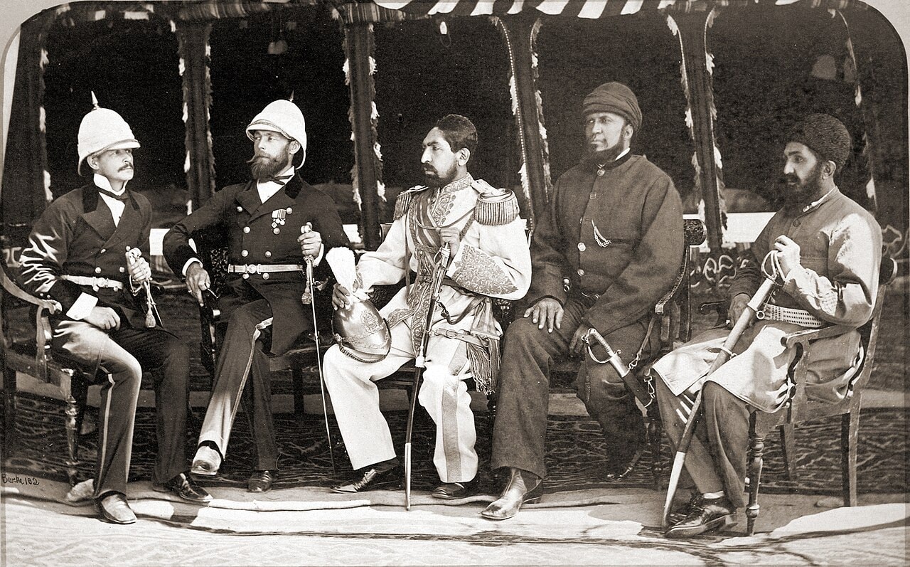 A formal photograph of five seated men: Amir Yaqub Khan, three of his officials and two British officers.