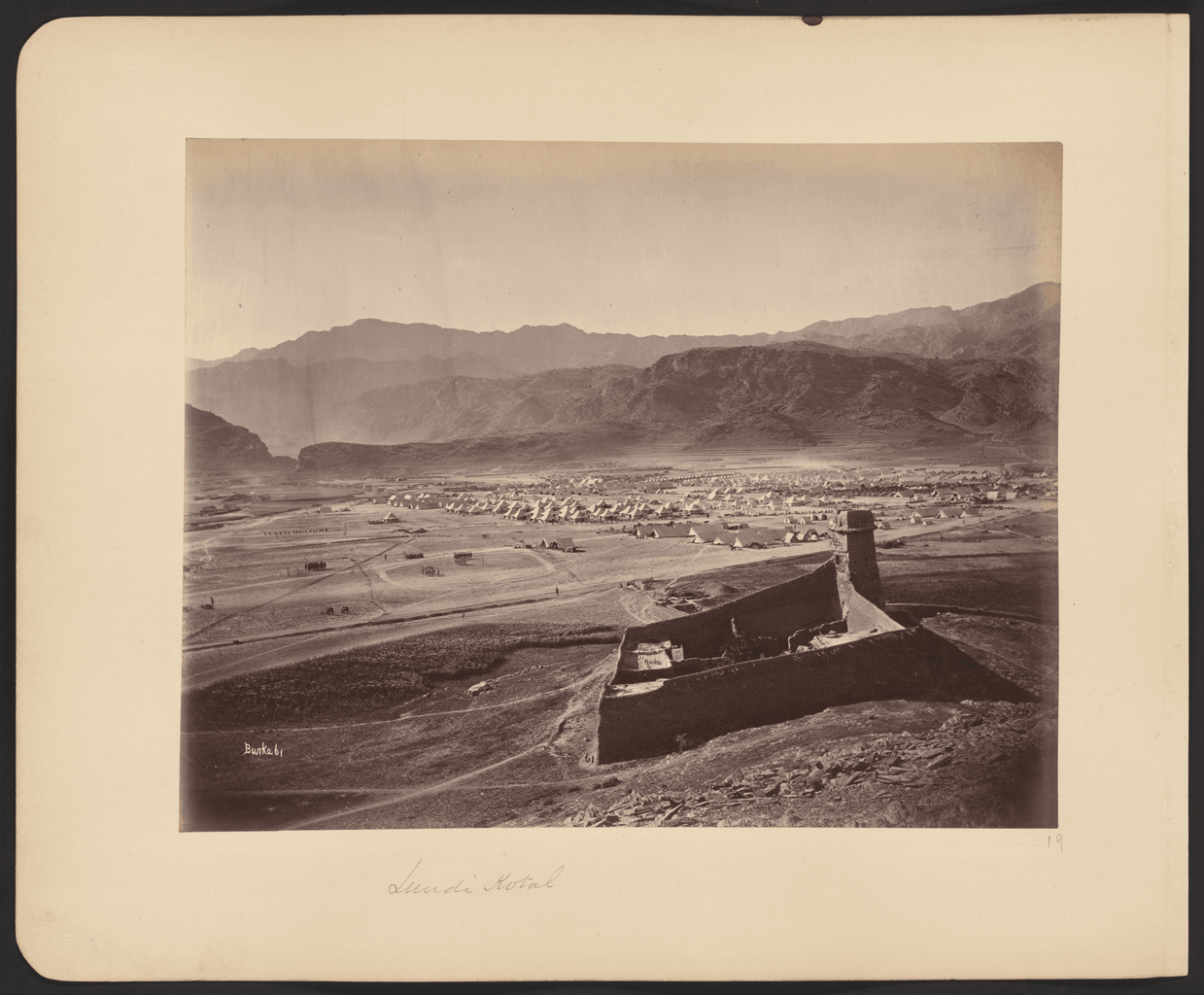 A black-and-white photograph of Landi Kotal and its surrounding hills.