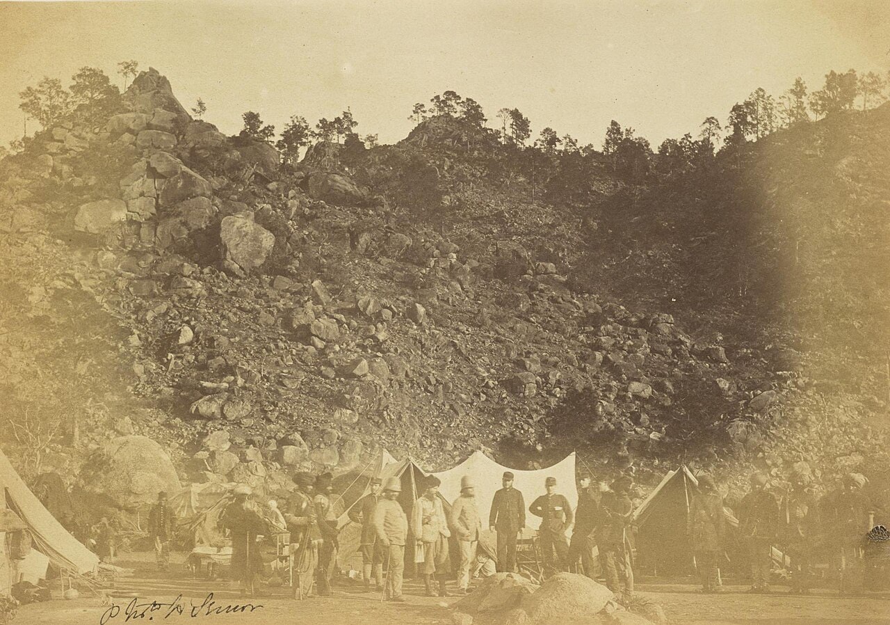 A photograph of British officers and three Sikh soldiers posed at the Umbeyla Pass.