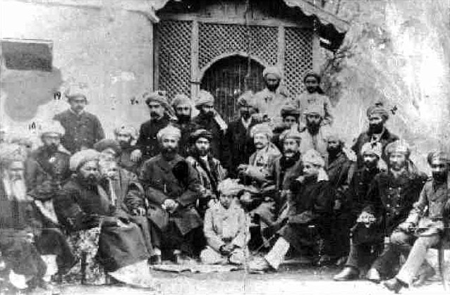Group photograph of Afghan men in a courtyard.