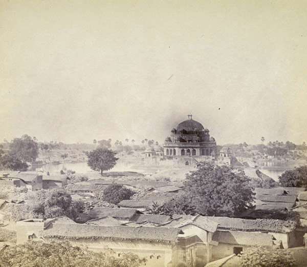 A black-and-white photograph of Sher Shah's tomb standing in a large tank at Sasaram.