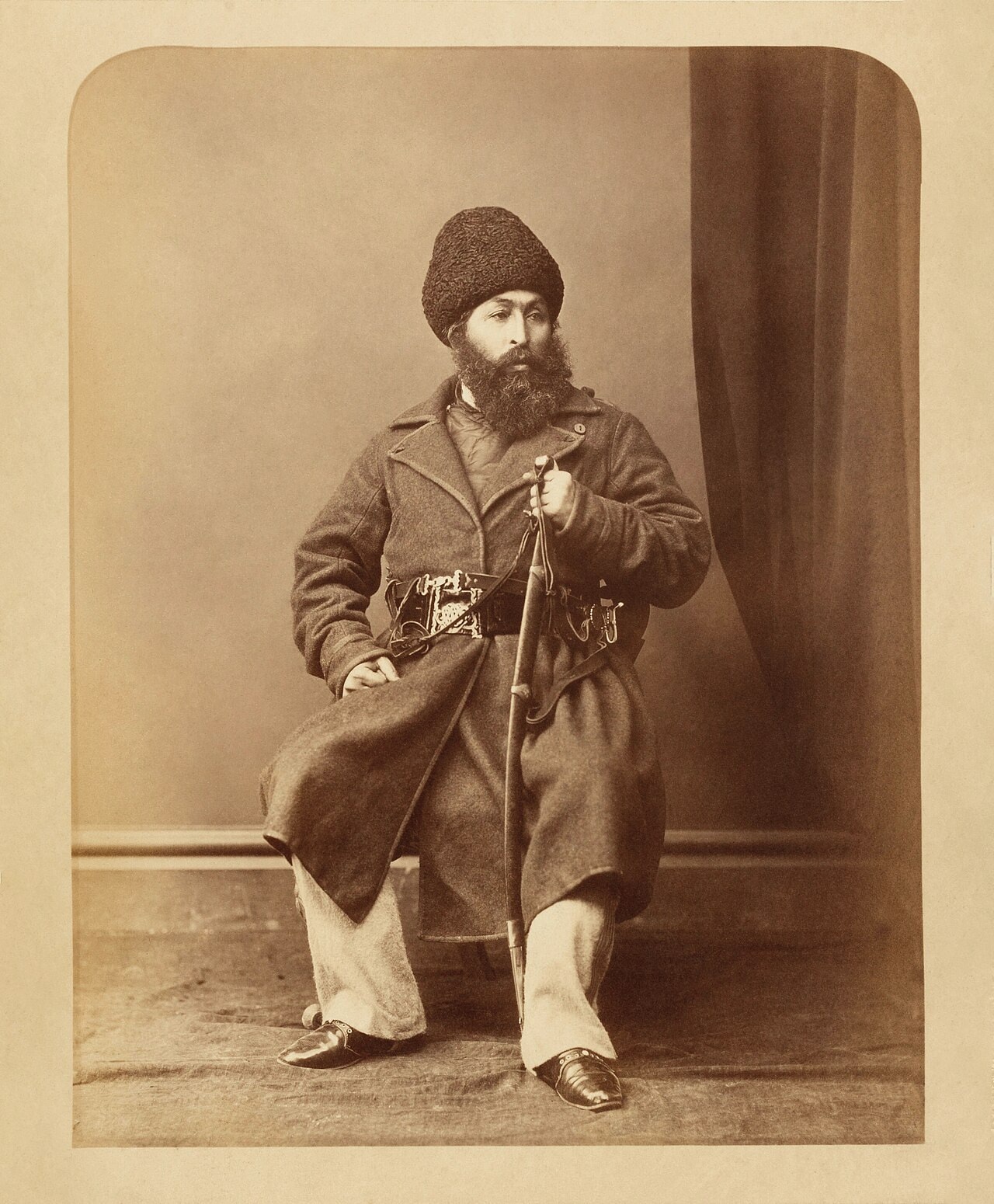 A black-and-white studio portrait photograph of Amir Sher Ali Khan.