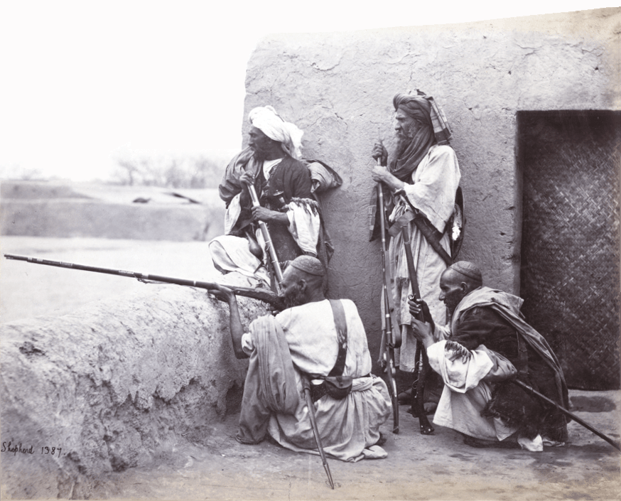 A group of Afridi men standing and sitting with rifles at Jamrud.