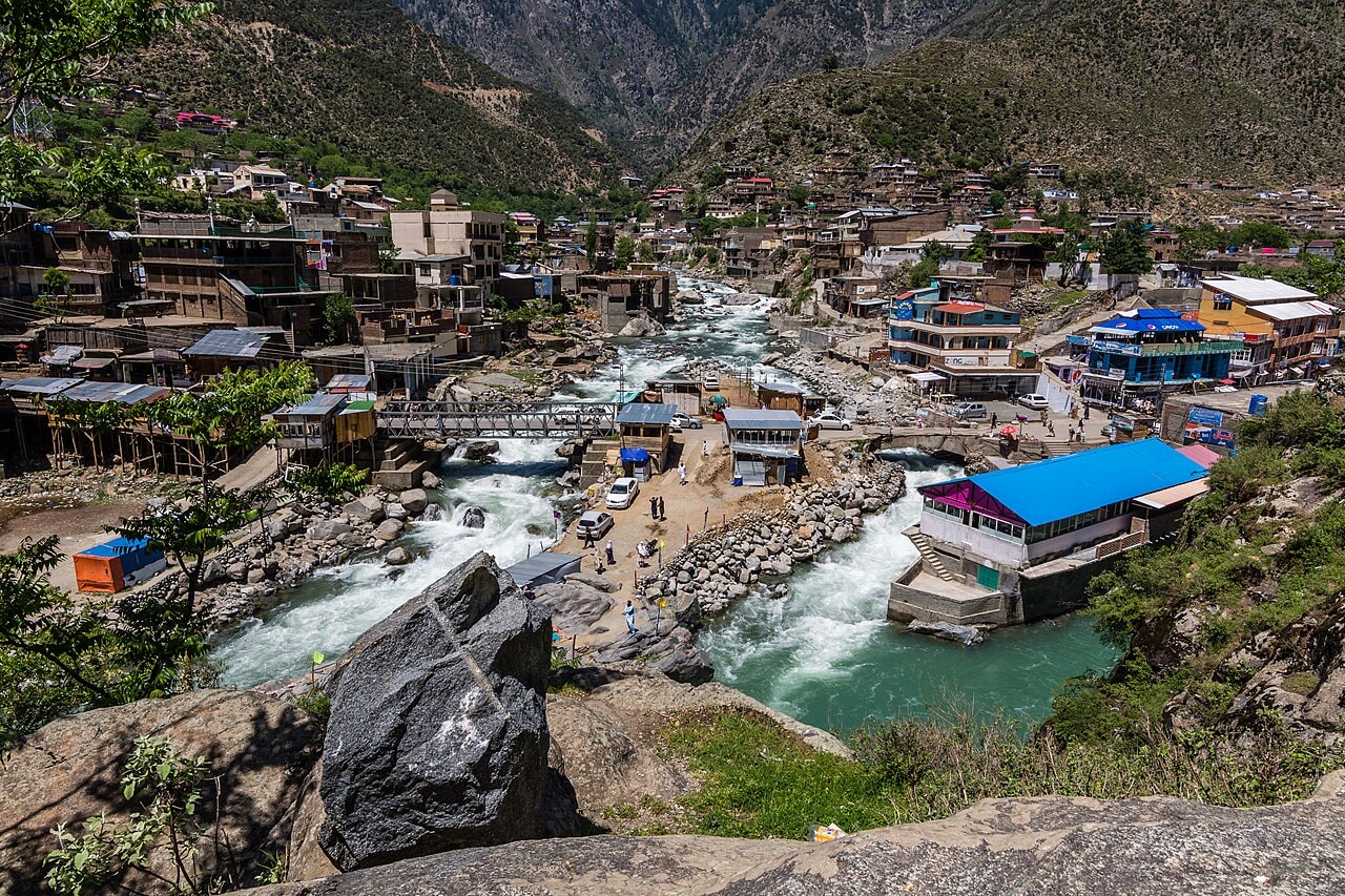 Green valley with a river and mountains.