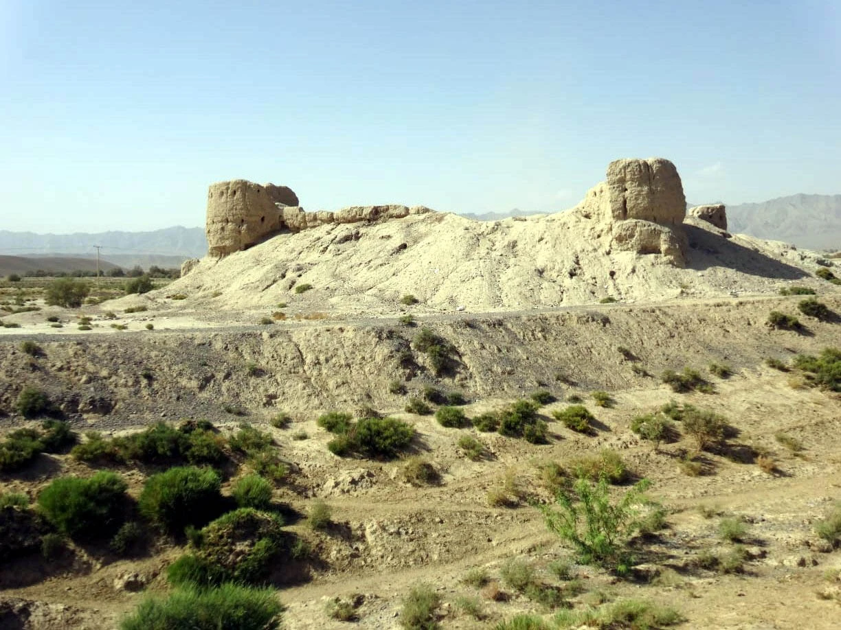 Eroded mud walls of an old fort on a low mound