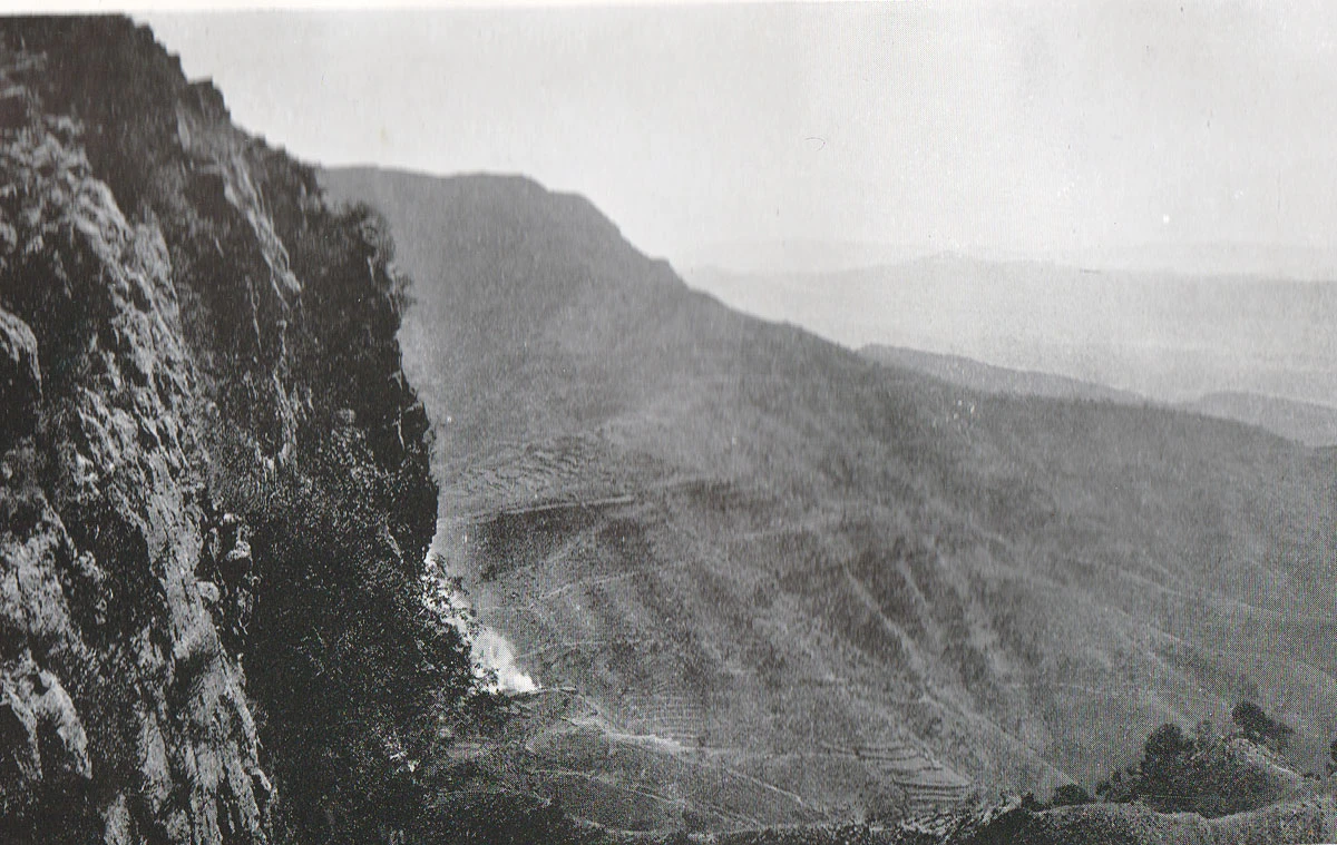 Steep rocky cliffs and ridges of the Dargai heights under a pale sky
