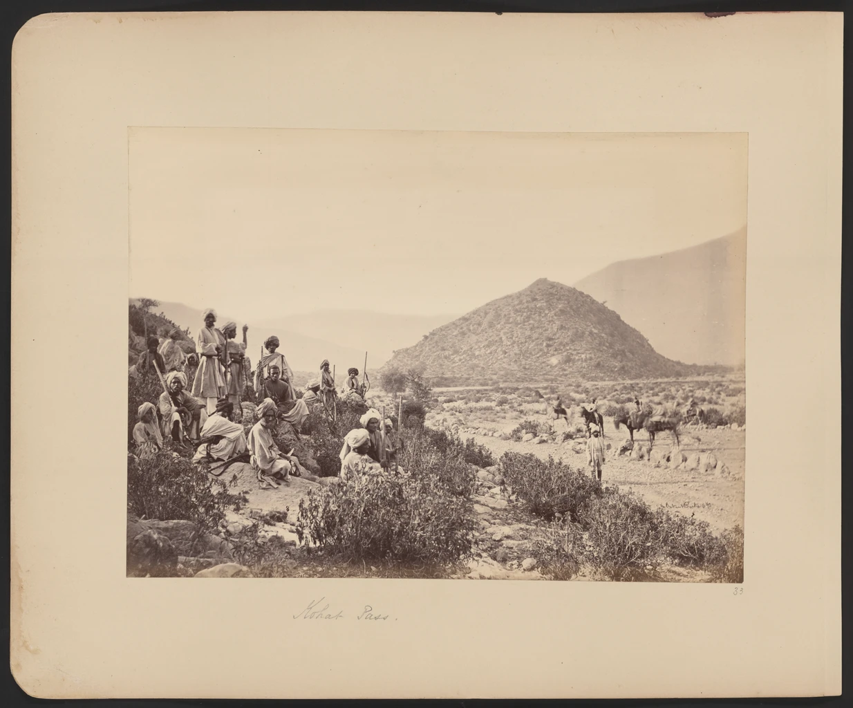 Old photograph of a group of men standing on a rocky hillside