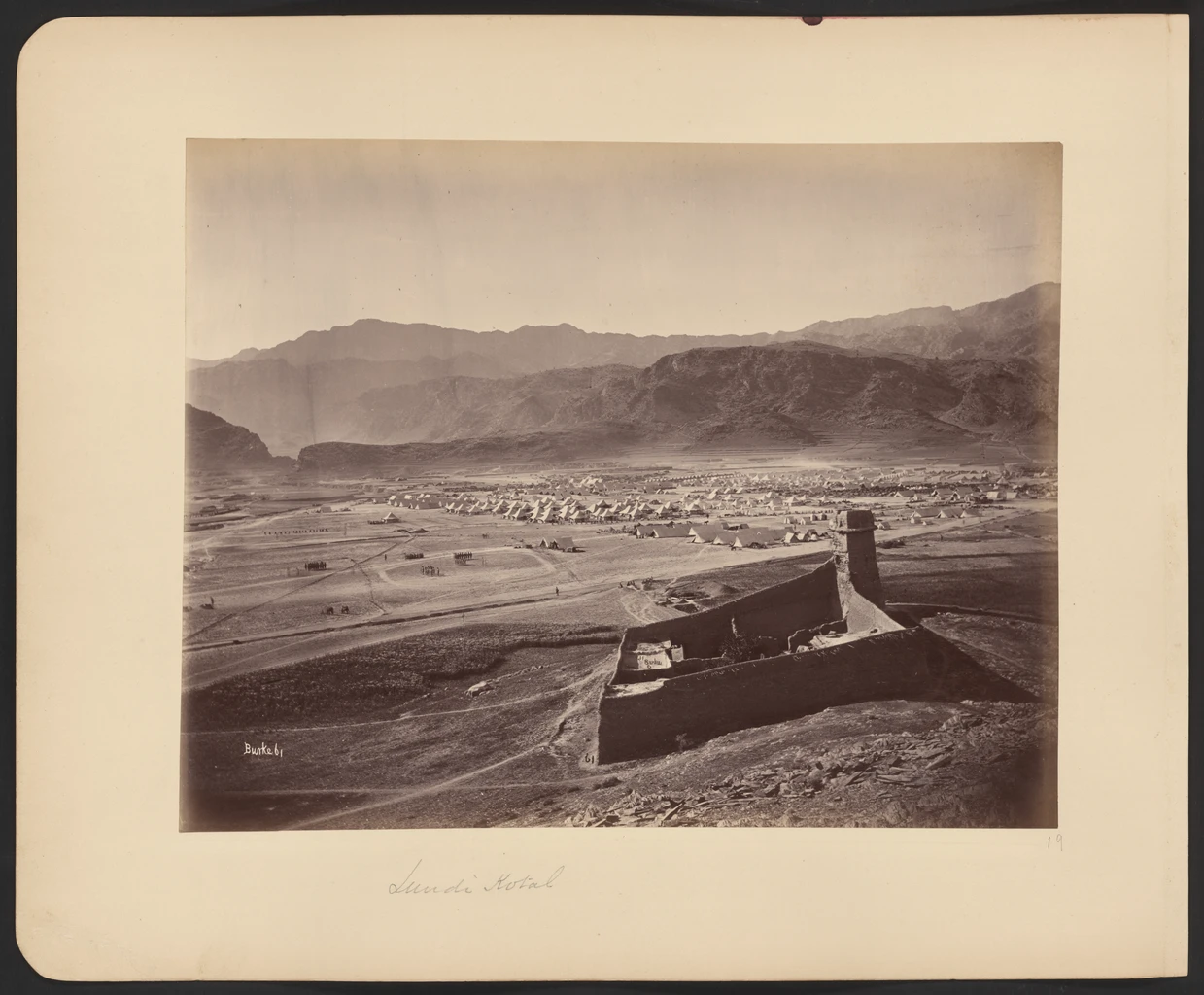 A black-and-white photograph of Landi Kotal and its surrounding hills.