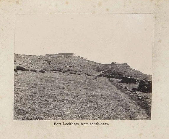 A walled fort with towers on a bare ridge