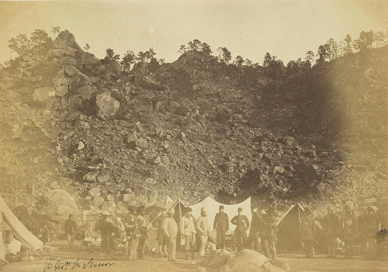 A photograph of British officers and three Sikh soldiers posed at the Umbeyla Pass.