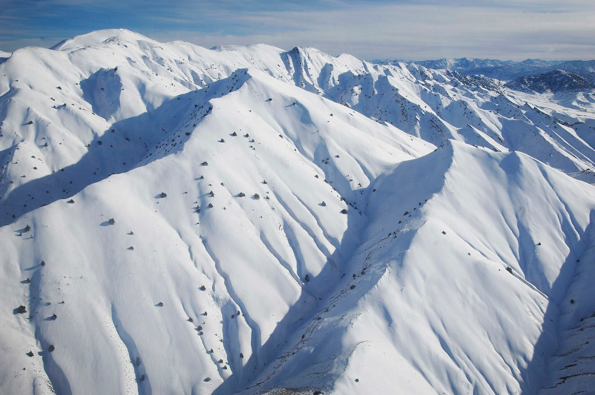 Steep mountain ridges covered in deep snow