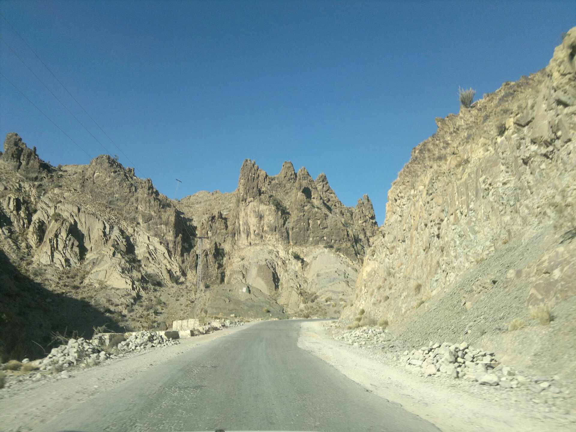Bare brown ridges under a pale sky near the town of Zhob