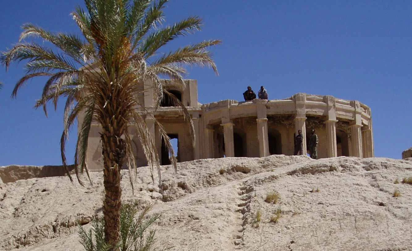 Eroded mud-brick walls of the old citadel of Farah on a low mound