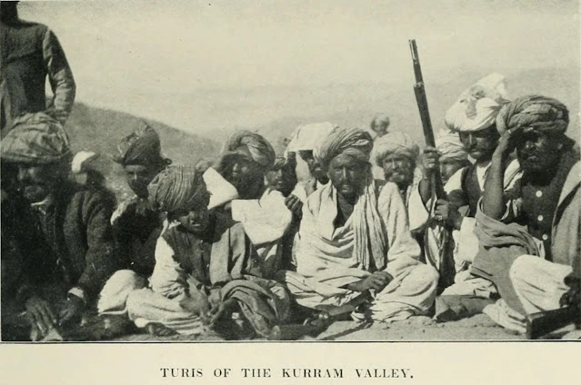 A group of armed men in turbans standing outdoors